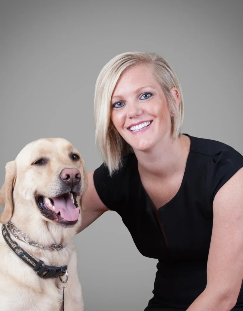 Dr. BreAnne Feldman, Veterinarian at Foxmoor Veterinary Clinic, posing with a dog